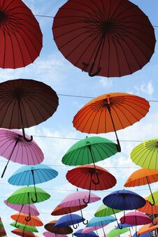 Street Installation With Colorful, Beautiful Umbrellas Floating In The Air Against The Sky. Royalty Free Stock Image