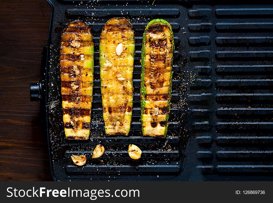 Spicy hot grilled zucchini, cooked on an electric grill. Banner. The concept of healthy eating and delicious food.