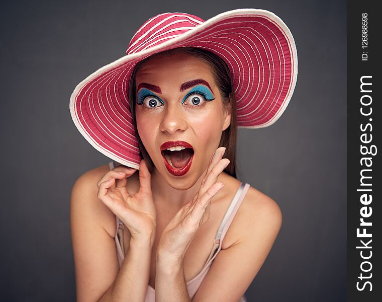 Surprising woman wide angle portrait. Funny close up face.