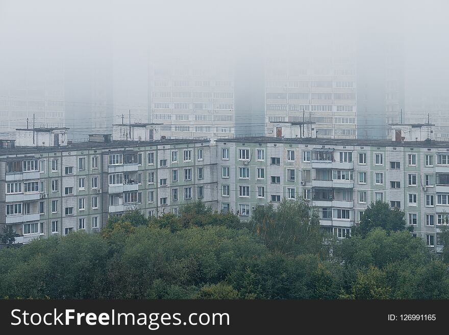 Morning mist over panel houses in early autumn