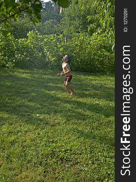 Boy snatching water in the garden