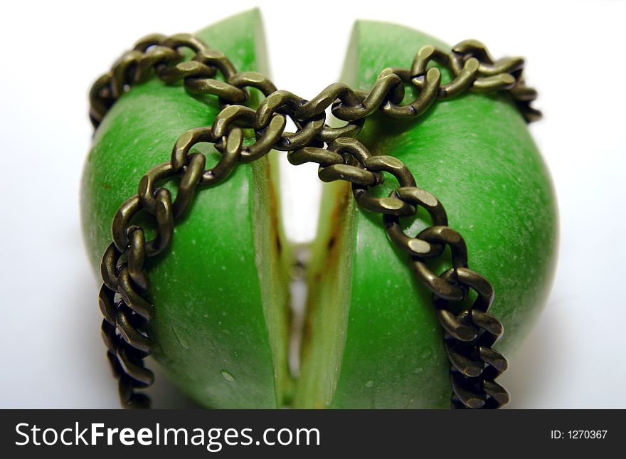 Cutted apple, locked between chains. Cutted apple, locked between chains.