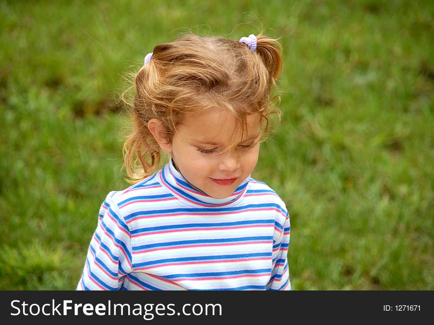 A young girl walking out doors with her hair in pigtails. A young girl walking out doors with her hair in pigtails.