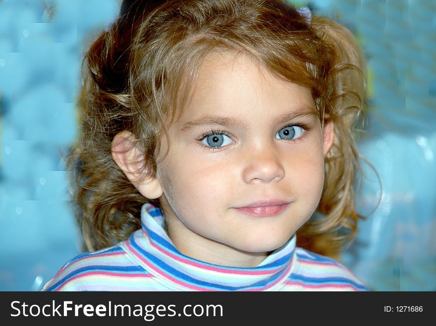 A young girl with big blue eyes and pigtails and curls. A young girl with big blue eyes and pigtails and curls