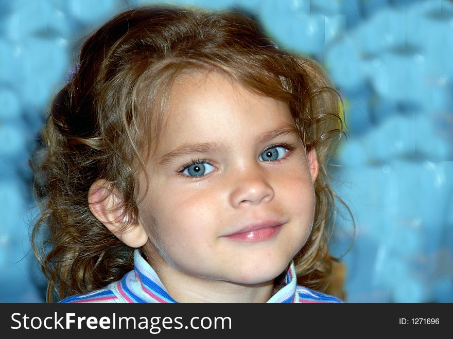 A young girl with big blue eyes and pigtails and curls. A young girl with big blue eyes and pigtails and curls