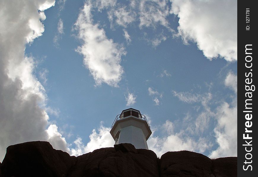 A tall standing lighthouse with sky circling it. A tall standing lighthouse with sky circling it