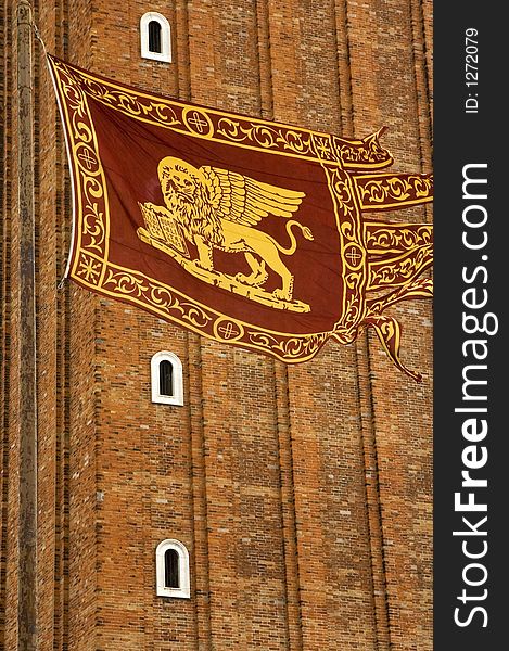 A closeup of Venice's St Marco's cathedral with venetian flag. A closeup of Venice's St Marco's cathedral with venetian flag