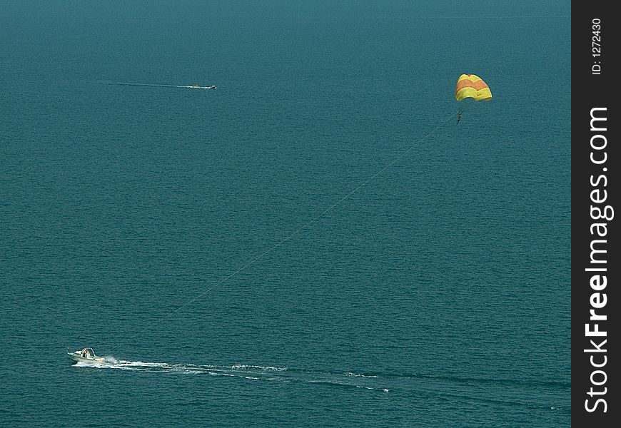 Parachute and boat in sea