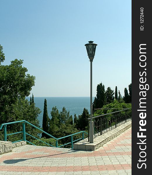 Pathway to sea, staircase and lamp