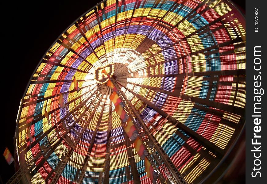 Motion blur of ferris wheel at night