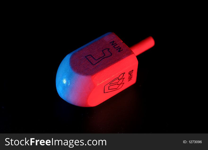 Photo of a Dreidel With Red and Blue Gel Lighting