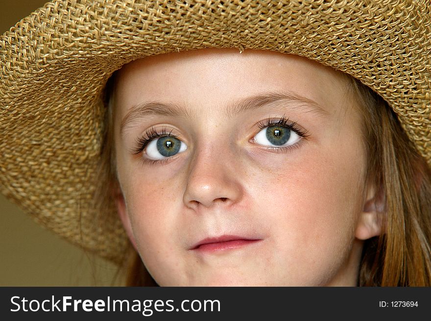 Little girl wearing straw hat with big eyes. Little girl wearing straw hat with big eyes