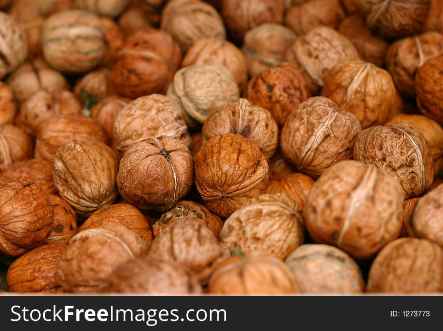 A lot of walnuts on the market display.