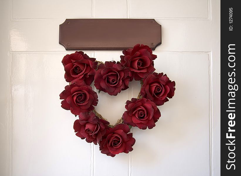Roses on a door with a plaque to place your own message. Roses on a door with a plaque to place your own message.