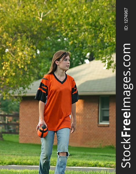 Girl holding football playing backyard football. Girl holding football playing backyard football