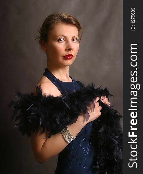 Portrait of the beautiful woman in an evening dress with feathers. Portrait of the beautiful woman in an evening dress with feathers