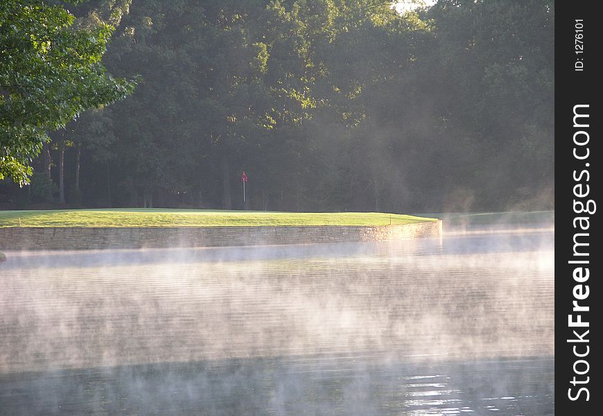 Golf hole in the morning fog. Golf hole in the morning fog