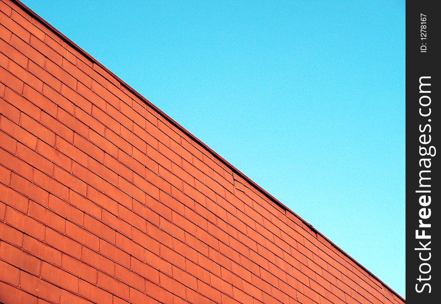 Red wall and blue sky
