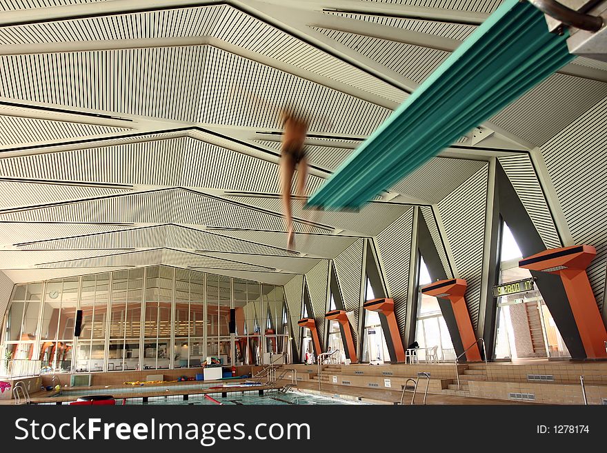 Indoor swimming pool fun, girl diving