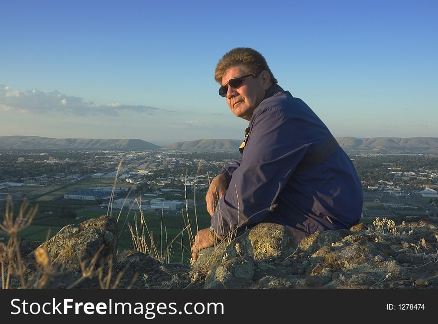 One adult on top of mountain overlooking the Yakima valley in Washington state. One adult on top of mountain overlooking the Yakima valley in Washington state