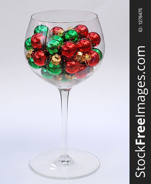 Christmas ornaments in a wine glass. Christmas ornaments in a wine glass.