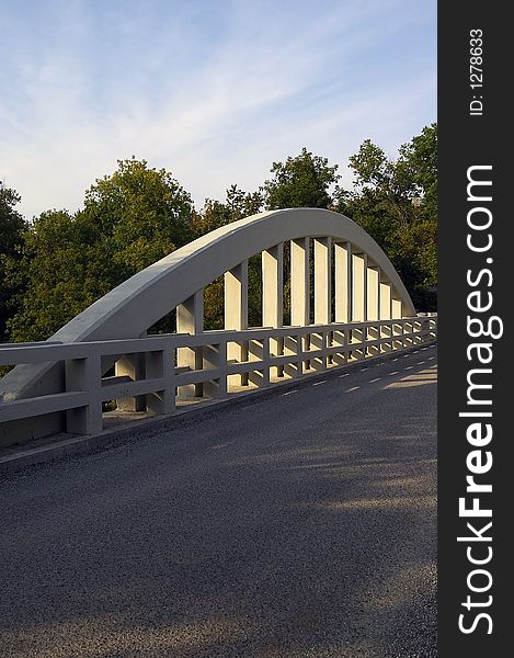 Structural concrete bridge arch on a single-lane country bridge.