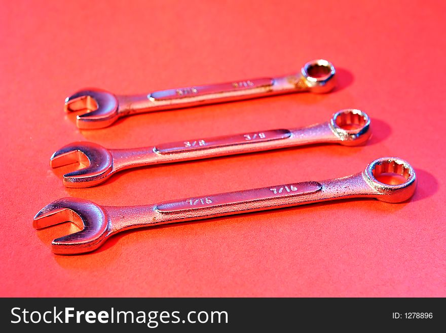 Three Wrench tools on red background