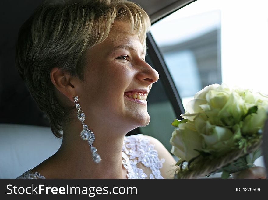 The laughing bride in the car. The laughing bride in the car