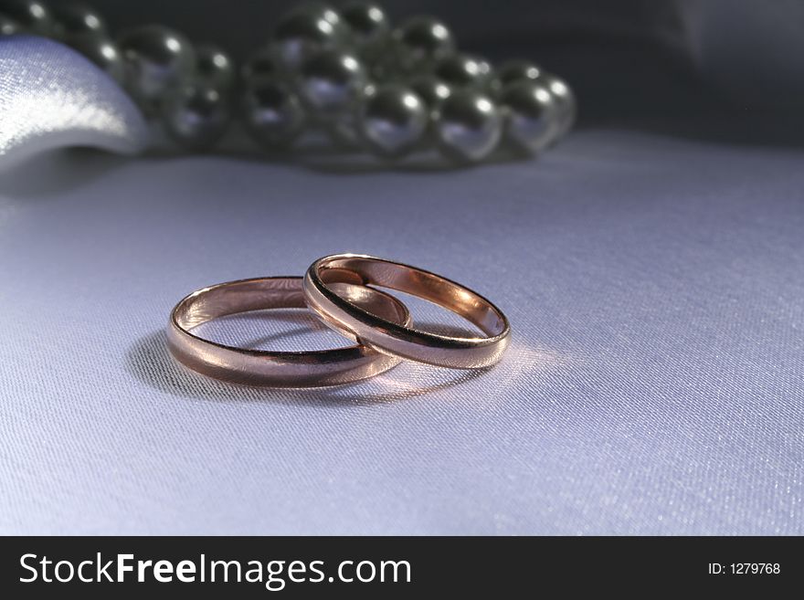 Wedding rings on a silk background