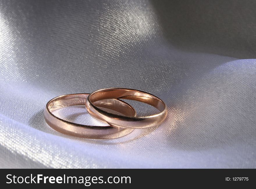 Wedding rings on a silk background