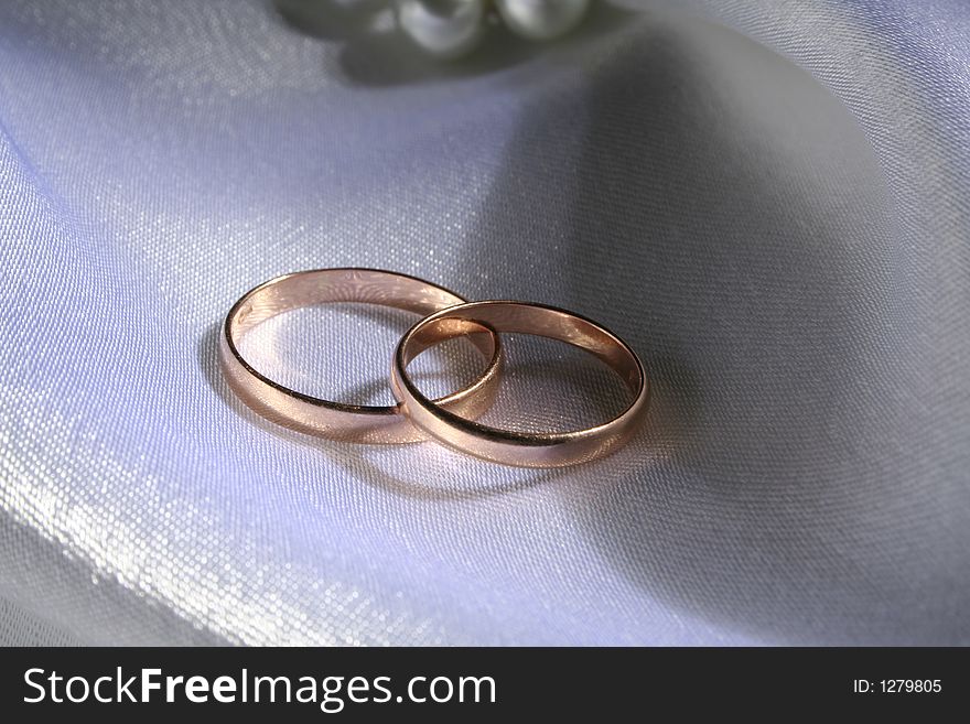 Wedding rings on a silk background