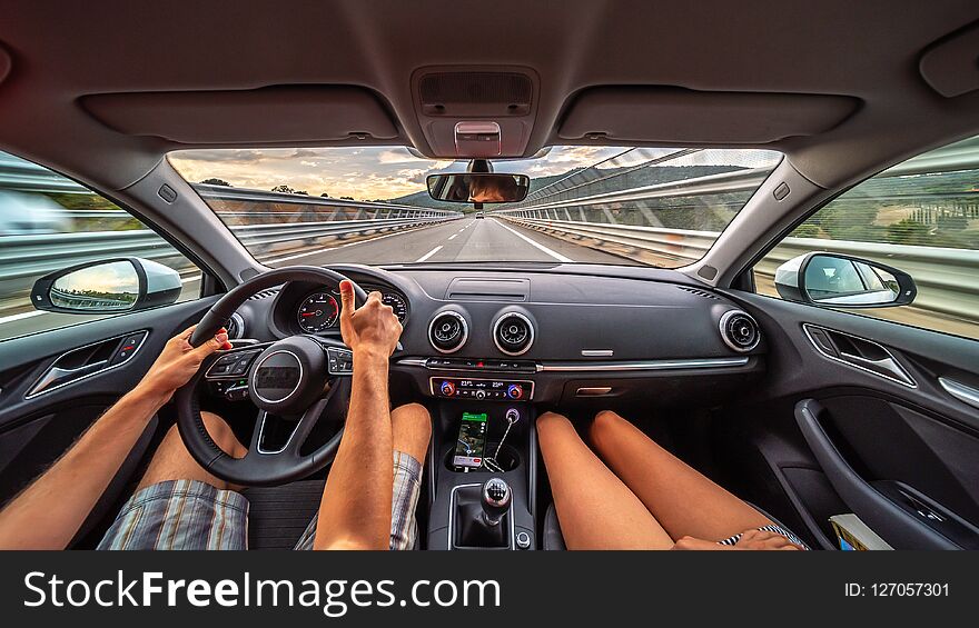 Driver`s hands on a steering wheel of a car