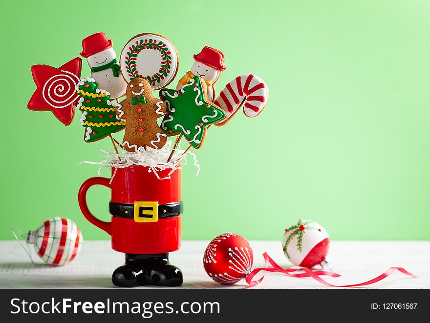 Set of Christmas gingerbread on sticks in a red gift cup. Christmas concept with copy space. Set of Christmas gingerbread on sticks in a red gift cup. Christmas concept with copy space.