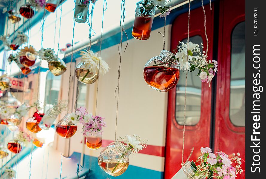 Herbal tea bottles with flowers hanging on strings. Herbal tea bottles with flowers hanging on strings