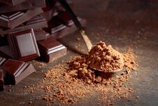 Broken Chocolate Pieces And Cocoa Powder . Royalty Free Stock Photos
