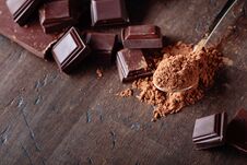 Broken Chocolate Pieces And Cocoa Powder . Stock Photography