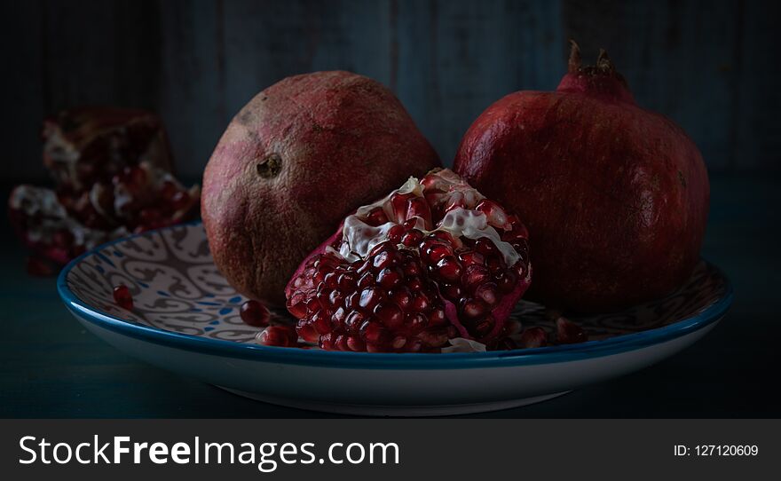 Still life grenade fruit. Feed on a black background.