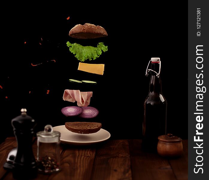 A sandwich in detail in the air on a black background. A sandwich in detail in the air on a black background