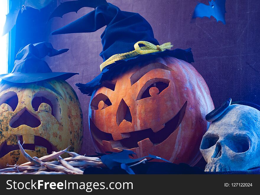 Halloween pumpkins in blue light, scary skull, Halloween background,