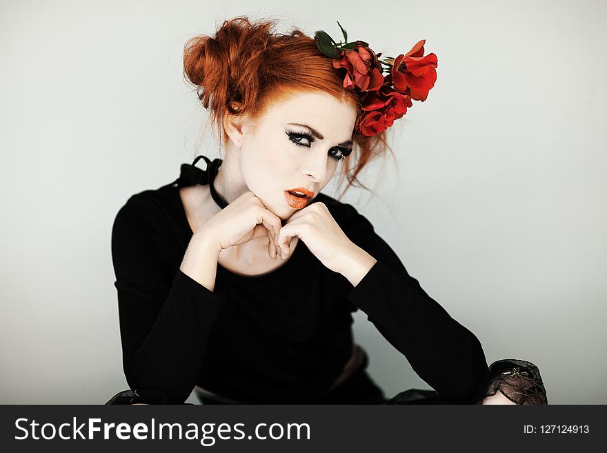 Beautiful, cute woman with halloween make up and red hair
