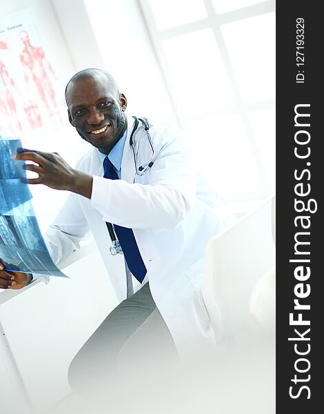 Portrait young african medical doctor holding patient`s x-ray.