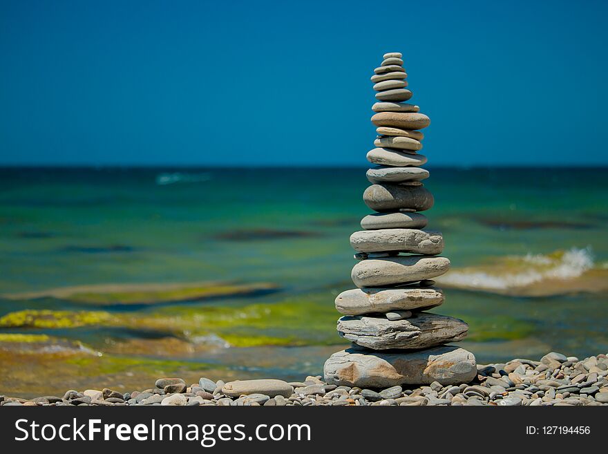 Stones balance on beach.