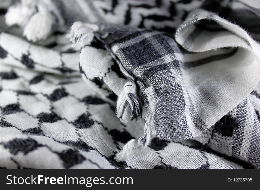 This is a photo of black and white arabic scarf. This is a photo of black and white arabic scarf