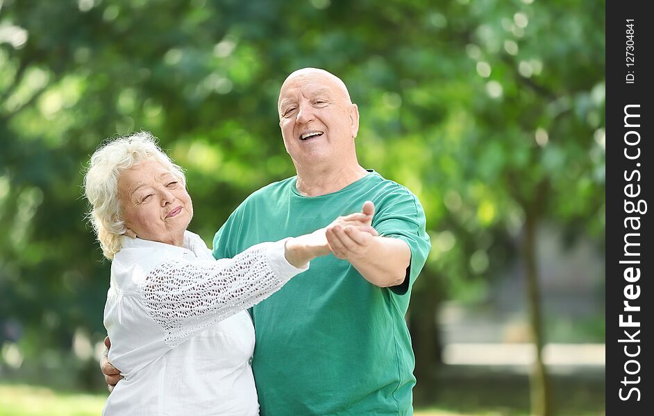 Cute Elderly Couple Dancing Outdoors.