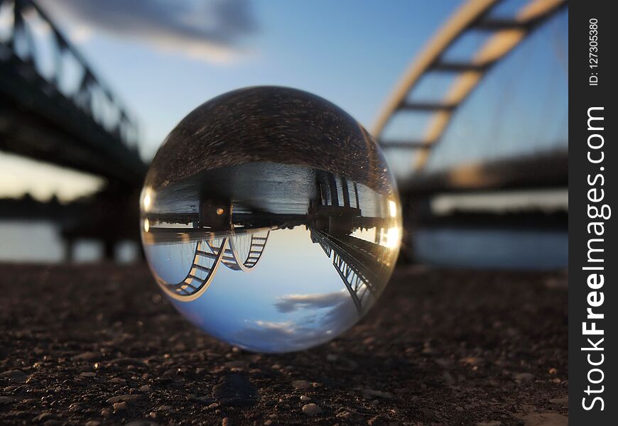 Two bridges on the river Danube reflection in crystal ball