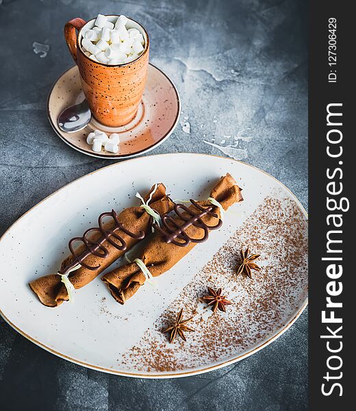 Chocolate pancake with cinnamon, anise and cup of coffee with marshmallow. Dessert and coffee