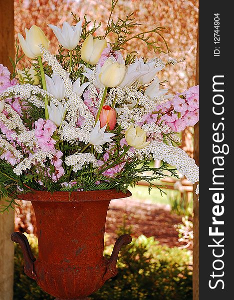 Beautiful white and pink spring flower bouquet in old rusty vase. Beautiful white and pink spring flower bouquet in old rusty vase