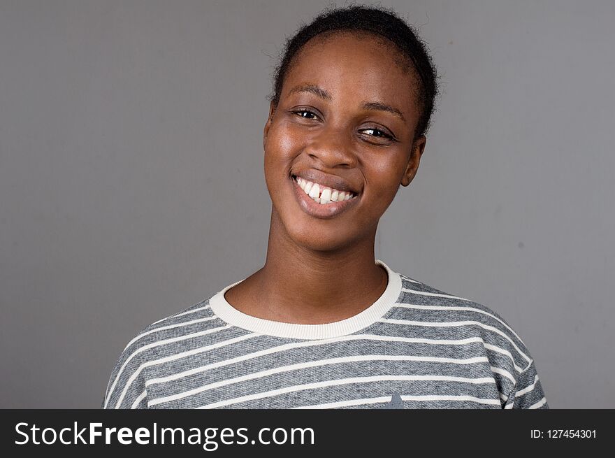 Portrait Beautiful happy woman with white teeth on a gray background. Portrait Beautiful happy woman with white teeth on a gray background