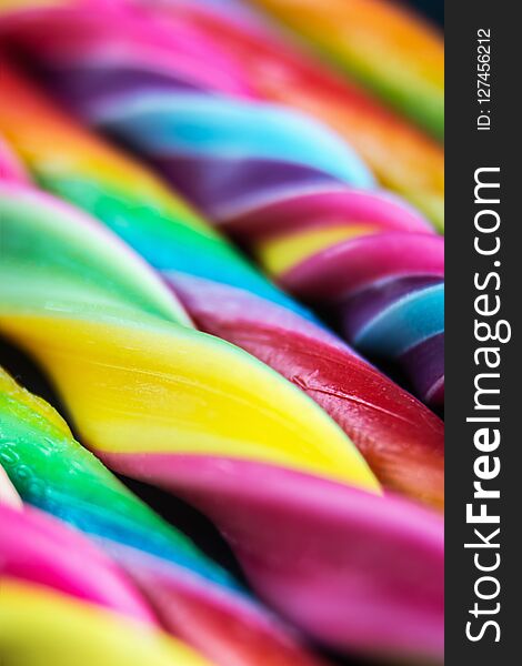 Candy canes of different colors of the rainbow. Soft focus, shallow depth of field