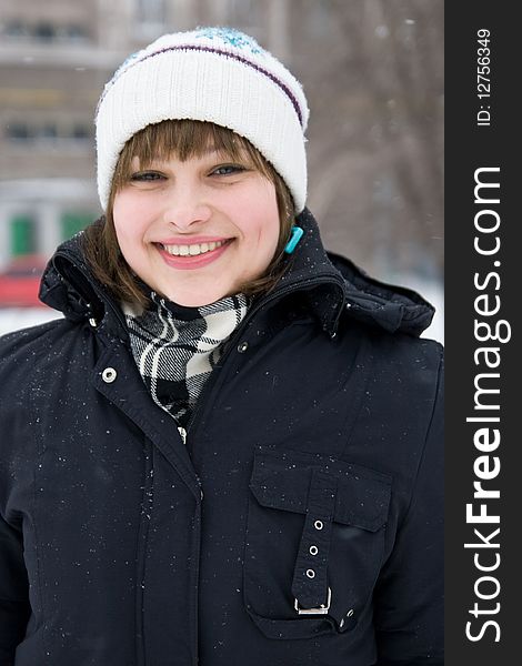 Portrait of a smiling chick in a snowy winter day. Portrait of a smiling chick in a snowy winter day